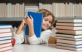 Smart pupil. Knowledge and education school concept. School boy pupil reading book in library. Kids learn to read. Child Royalty Free Stock Photo