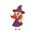 Smart red-haired girl witch reading books and wearing purple dress, hat and glasses. Smiling kid character in Halloween Royalty Free Stock Photo