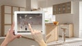 Smart remote home control system on a digital tablet. Device with app icons. Blurry interior of minimalist kitchen in the backgrou Royalty Free Stock Photo