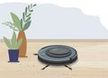 Smart robot vacuum cleaner in a modern living room. Wooden flooring, laminate flooring and potted plants. Modern smart home Royalty Free Stock Photo