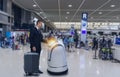 Smart robotic technology concept, The passenger follow a service robot to a counter check in in airport, the robot can help and gi