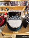 Smart robotic vacuum cleaner on display in electronics store showcasing advanced technology and design features for