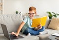 Smart school boy with glasses doing homework at home Royalty Free Stock Photo