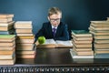 Smart school boy reading a book at library Royalty Free Stock Photo