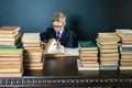 Smart school boy reading a book at library Royalty Free Stock Photo