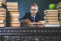 Smart school boy reading a book at library Royalty Free Stock Photo