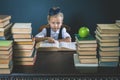 Smart school girl reading a book at library Royalty Free Stock Photo