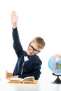 smart schoolboy pulls his arm while sitting Royalty Free Stock Photo
