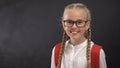Smart schoolgirl in eyeglasses smiling on camera, thirst for knowledge education