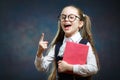 Smart Schoolgirl Hold Book Point Index Finger up