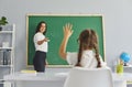 Smart schoolgirl ready to do an easy sum in a lesson in school