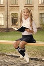 Smart schoolgirl. Schoolgirl reading book. Little genius. Schoolgirl relaxing sit bench with book. Time to study