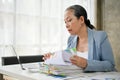 Smart senior businesswoman working in her office room with stack of papers Royalty Free Stock Photo