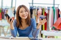 Smart shop owner happy with credit card payment and smartphone internet banking for customer pay