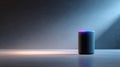 A smart speaker with a glowing top sits on the table in dim lighting Royalty Free Stock Photo