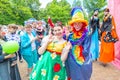 smart street actors, buffoons and clowns at a flower festival on a summer day