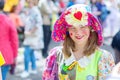 Smart street actors, buffoons and clowns at a flower festival on a summer day