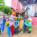 smart street actors, buffoons and clowns at a flower festival on a summer day