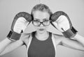 Smart and strong. Woman boxing gloves adjust eyeglasses. Win with strength or intellect. Strong intellect victory pledge