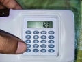 Smart student holding small calculator for solving maths Royalty Free Stock Photo