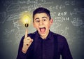 Smart student with idea light bulb science formulas on blackboard Royalty Free Stock Photo