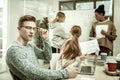 Smart skillful postgraduate student sitting in front of his laptop