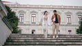 Smart students strolling stairs after exam. Relaxed couple enjoying conversation Royalty Free Stock Photo