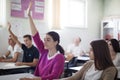 Teenagers students sitting in the classroom raise hands. Portrait of student girl Royalty Free Stock Photo