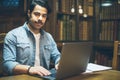 Smart study mood. Young arabic man working in library Royalty Free Stock Photo