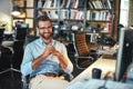 Smart and successful. Young and cheerful bearded man in eyeglasses and formal wear working on computer and smiling while Royalty Free Stock Photo