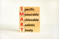 SMART symbol. Concept words SMART specific measurable achievable realistic timely on wooden block. Beautiful white background. Royalty Free Stock Photo