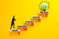 SMART symbol. Concept words SMART specific measurable attainable relevant time-based on block. Beautiful yellow background. Royalty Free Stock Photo