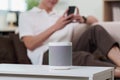 Smart Technology. A man using voice assistant with smart speaker at home. Royalty Free Stock Photo