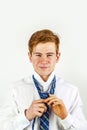 Smart teen boy knots his tie Royalty Free Stock Photo