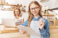 Smart teenage girl taking order in cafe