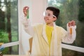 Smart pupil, teenage schoolboy in protective goggles and white lab coat, makes scientific experiments in chemistry class