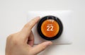 Smart Thermostat with a person warming up the room temperature with a soft shadow Royalty Free Stock Photo