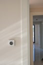 Smart Thermostat on White Wall for Optimal Home Temperature Control Royalty Free Stock Photo