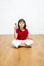 Smart thinking little girl holding key for concept of solution Royalty Free Stock Photo