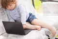 Smart toddler girl using laptop computer, child and technology Royalty Free Stock Photo