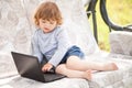 Smart toddler girl using laptop computer, child and technology. Royalty Free Stock Photo