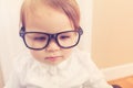 Smart toddler girl wearing big glasses using her laptop Royalty Free Stock Photo