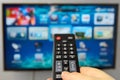 Smart tv and hand hold remote control Royalty Free Stock Photo