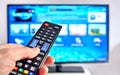 Smart tv and hand pressing remote control Royalty Free Stock Photo