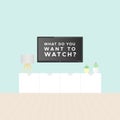 Smart TV in the living room. Tv stand, light blue wall, wooden floor, plants and table lamp. Television text: `What do you want t Royalty Free Stock Photo