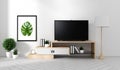 Smart Tv Mockup with blank black screen hanging on the cabinet and fame decor, modern living room zen style. 3d rendering