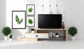 Mock up Smart Tv Mockup with blank black screen hanging on the cabinet and fame decor, modern living room zen style. 3d rendering