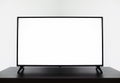 Smart TV mockup, Close up of LCD 4K television with blank screen standinding on TV stand.