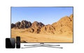 Smart tv and multimedia box with remote controller and mountain landscape wallpaper on screen