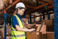 Smart warehouse management staff using laptop computer monitor inventory software system to check and manage cargo products stock Royalty Free Stock Photo